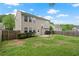 Spacious backyard featuring mature trees, green grass and a patio with pergola at 216 Diamond Valley Pass, Canton, GA 30114