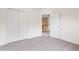 Carpeted bedroom featuring closet and doorway to the hallway at 216 Diamond Valley Pass, Canton, GA 30114