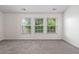 Bright bedroom featuring three large windows overlooking backyard at 216 Diamond Valley Pass, Canton, GA 30114