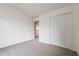 Bedroom with carpet, closet, and doorway to the hallway at 216 Diamond Valley Pass, Canton, GA 30114