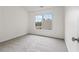 Bright bedroom featuring a large window and neutral carpet at 216 Diamond Valley Pass, Canton, GA 30114