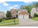 Charming two-story home with brick and siding, lush landscaping, and a two-car garage at 216 Diamond Valley Pass, Canton, GA 30114