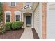 Inviting front entrance with a blue door, manicured bushes, and fresh mulch at 216 Diamond Valley Pass, Canton, GA 30114