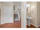 A hallway with a half bathroom, stairs to the second floor, and hard wood floors at 216 Diamond Valley Pass, Canton, GA 30114