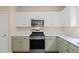 This updated kitchen features white cabinets, stainless steel appliances, and quartz countertops at 216 Diamond Valley Pass, Canton, GA 30114