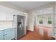 A modern kitchen features stainless steel appliances, access to the dinning room and wood floors at 216 Diamond Valley Pass, Canton, GA 30114