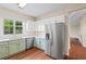 This kitchen features white cabinets, stainless steel appliances, and a view of the backyard at 216 Diamond Valley Pass, Canton, GA 30114