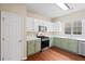 Modern kitchen with white and sage cabinets, stainless steel appliances, and hardwood floors at 216 Diamond Valley Pass, Canton, GA 30114