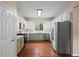 Well-equipped kitchen with white cabinets, stainless steel appliances, and hardwood floors at 216 Diamond Valley Pass, Canton, GA 30114