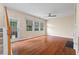Bright living room with hardwood floors, a ceiling fan, and a glass door that leads to the backyard at 216 Diamond Valley Pass, Canton, GA 30114