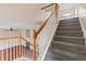 Carpeted staircase with wooden railing provides access to the upper level at 216 Diamond Valley Pass, Canton, GA 30114