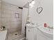 Modern bathroom featuring double sinks, stylish gray tiled shower, and unique heart mirror at 3999 Wabash Ln, Ellenwood, GA 30294