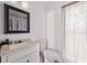 Bathroom with a light colored vanity with a mirror and a window with a shade at 3999 Wabash Ln, Ellenwood, GA 30294