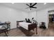 Bright bedroom featuring wood floors, a ceiling fan, and an accessible bed with dark wood trim at 3999 Wabash Ln, Ellenwood, GA 30294