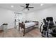 Well-lit bedroom featuring wood-look flooring, ceiling fan, and an accessible bed frame at 3999 Wabash Ln, Ellenwood, GA 30294