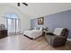 Cozy bedroom with wood flooring, vaulted ceiling, and arched window offering ample natural light at 3999 Wabash Ln, Ellenwood, GA 30294