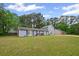Inviting single-story home with expansive lawn, mature trees, and classic curb appeal at 3999 Wabash Ln, Ellenwood, GA 30294