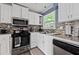 Well-lit kitchen featuring stainless steel appliances, modern cabinetry, and attractive backsplash at 3999 Wabash Ln, Ellenwood, GA 30294