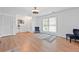Bright and open living room featuring hardwood floors, stylish decor, and ample natural light at 3999 Wabash Ln, Ellenwood, GA 30294