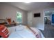 Bright bedroom with wood floors, TV, console table, and natural light from the window at 831 Catherine St, Forest Park, GA 30297