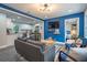 Stylish living room showcasing bright blue accent wall, modern furniture, and an open layout to the kitchen at 831 Catherine St, Forest Park, GA 30297