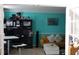 Cozy living room with bright teal walls, and a yellow couch, perfect for relaxing and entertaining at 8871 Jimmy Lee Cir, Jonesboro, GA 30238