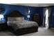 Elegant main bedroom showcasing a large bed, stylish decor, and soft natural light filtering through the window at 8871 Jimmy Lee Cir, Jonesboro, GA 30238