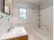 Bathroom featuring white subway tile surround, and tub with shower head and single vanity at 2783 Mount Olive Dr, Decatur, GA 30033