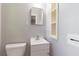 Bathroom featuring white fixtures, vanity sink, cabinet, and wall shelves for storage solutions at 2783 Mount Olive Dr, Decatur, GA 30033