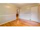 A bedroom featuring hardwood floors, decorative wall trim, interior door, and ample space at 2783 Mount Olive Dr, Decatur, GA 30033