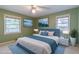Bedroom with a large bed, blue accents, two windows, and modern furniture creating a calming space at 2783 Mount Olive Dr, Decatur, GA 30033
