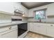 Bright kitchen featuring white cabinets, modern appliances, and a subway tile backsplash at 2783 Mount Olive Dr, Decatur, GA 30033