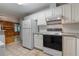Functional kitchen with white cabinets, modern appliances, and views into the living room at 2783 Mount Olive Dr, Decatur, GA 30033