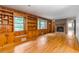 Spacious living room with hardwood floors, built-in bookshelves, and a brick fireplace at 2783 Mount Olive Dr, Decatur, GA 30033