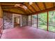 Enclosed porch with brick walls, wood ceiling, and views of the surrounding landscape at 2783 Mount Olive Dr, Decatur, GA 30033