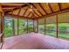 Spacious screened-in porch with wood ceiling, natural light, and views of the lush backyard at 2783 Mount Olive Dr, Decatur, GA 30033