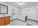 Clean bathroom with tiled floor, wooden vanity, toilet, and tub/shower combination at 488 Russell Rd, Lawrenceville, GA 30043