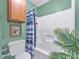 Cozy bathroom featuring a toilet, tub/shower, and decorative items at 488 Russell Rd, Lawrenceville, GA 30043