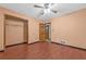 A well lit bedroom features hardwood floors and a large closet at 488 Russell Rd, Lawrenceville, GA 30043