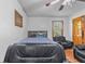 Bright bedroom with a ceiling fan and view of the backyard through the window at 488 Russell Rd, Lawrenceville, GA 30043
