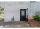 Back entrance of the home with a door and utility meter at 488 Russell Rd, Lawrenceville, GA 30043