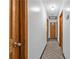 Neutral hallway with wood flooring and doors leading to bedrooms and bathrooms at 488 Russell Rd, Lawrenceville, GA 30043
