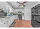Functional kitchen featuring white cabinetry, stainless steel appliances, and modern lighting at 488 Russell Rd, Lawrenceville, GA 30043
