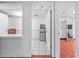 Kitchenette area with white tile floors, refrigerator, and sink with storage at 488 Russell Rd, Lawrenceville, GA 30043
