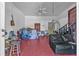 Unfinished living room with red flooring and a staircase, filled with furniture and belongings at 488 Russell Rd, Lawrenceville, GA 30043