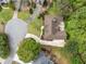 Overhead view of a house with a circular driveway and lush greenery in a residential neighborhood at 674 Owl Creek Ct, Powder Springs, GA 30127