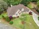 A bird's eye view of a beautiful brick home with manicured lawns and a circular driveway at 674 Owl Creek Ct, Powder Springs, GA 30127