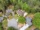 Aerial view of a property in a neighborhood, showcasing the house and surrounding greenery at 674 Owl Creek Ct, Powder Springs, GA 30127