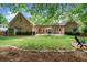 Spacious backyard with a brick patio, pergola, and well-maintained lawn at 674 Owl Creek Ct, Powder Springs, GA 30127