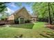 A beautiful home backyard featuring a lush green lawn, storage shed, and covered patio at 674 Owl Creek Ct, Powder Springs, GA 30127